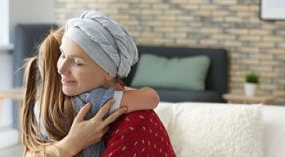 woman with cancer hugging child